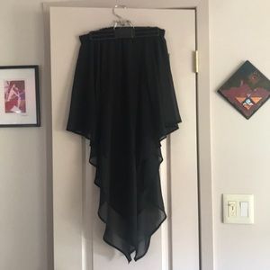Black mini skirt with sheer overlay.